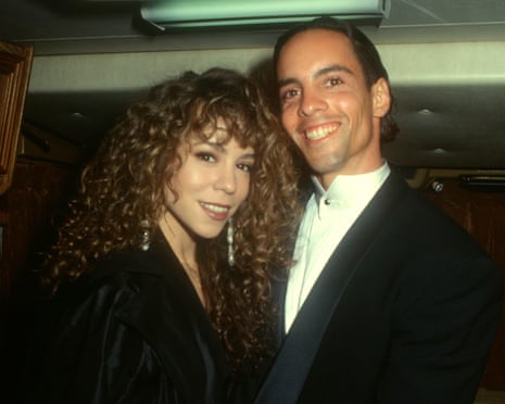 Mariah Carey and her brother Morgan Carey smile closely together at an event