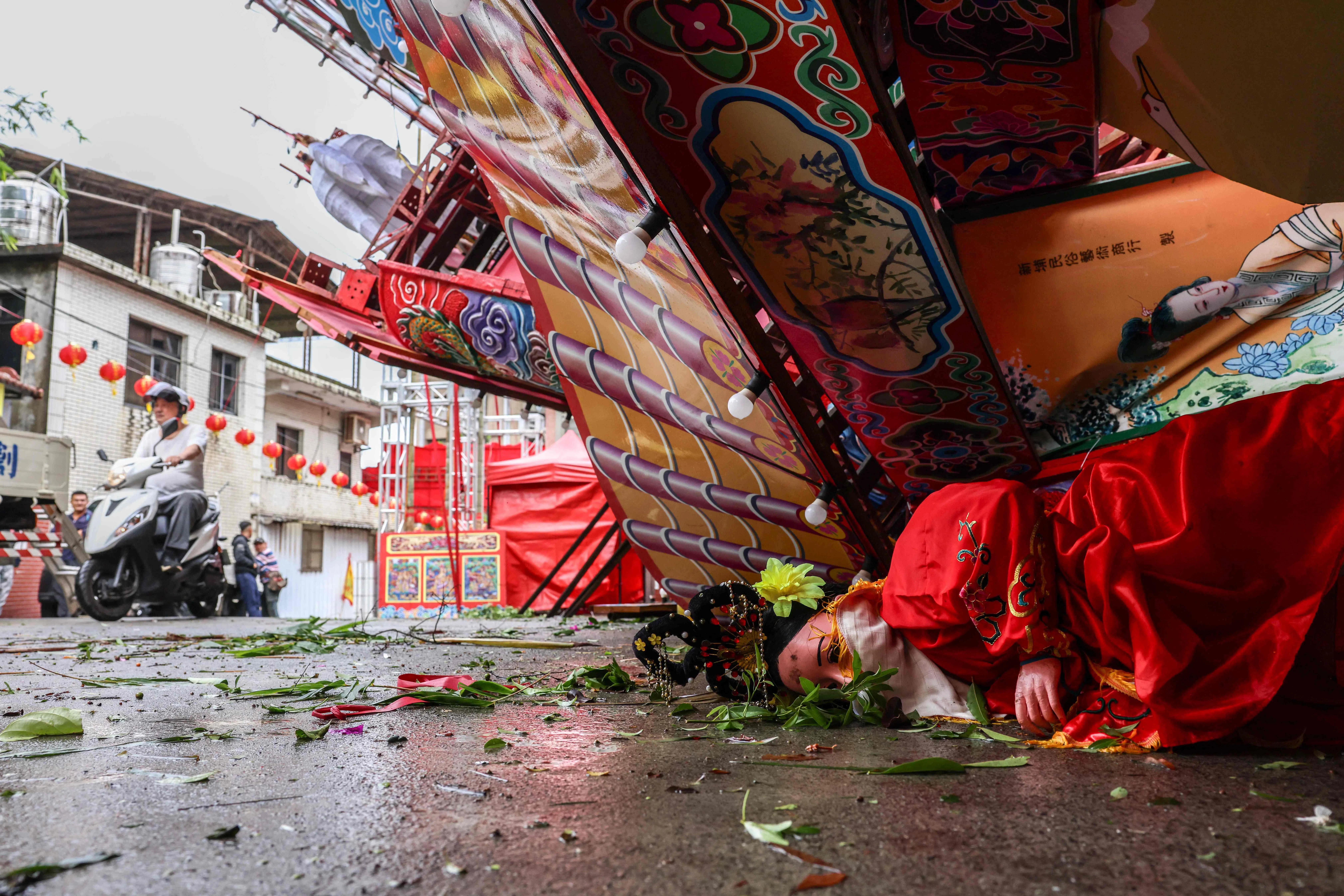 TOPSHOT - A temporary structure built for a traditional Taoist religious ceremony lies collapsed due to strong winds from Typhoon Champi in Keelung on October 24, 2026. Champi dumped heavy rain, toppled trees and knocked out power to thousands of households as it swept past Taiwan's northeast on the way to China and Japan. (Photo by I-Hwa Cheng / AFP)