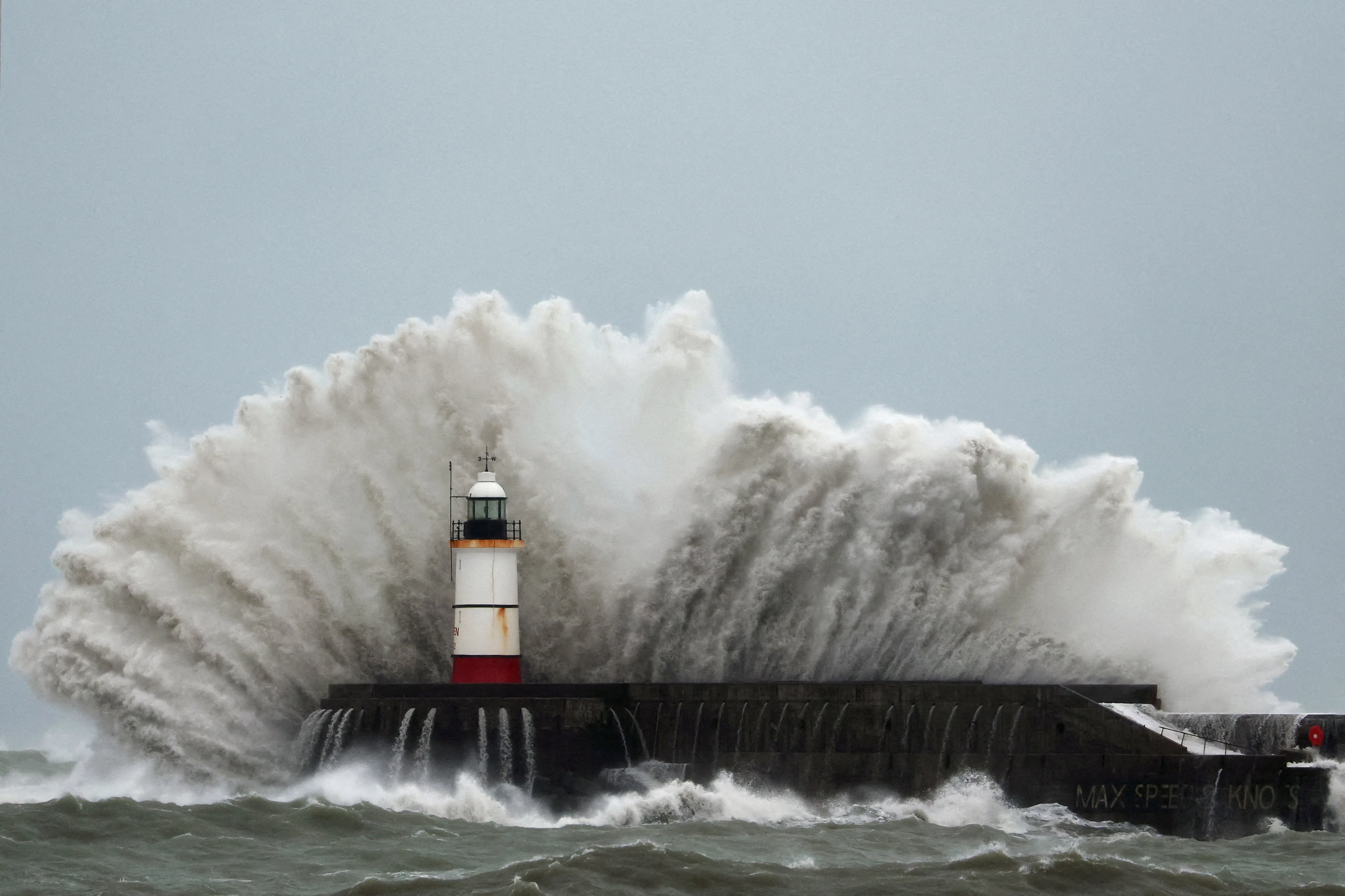 Waves crash over the lighthouse at Newhaven Harbour during Storm Austen in Newhaven, Britain, October 23, 2026. REUTERS/Toby Melville