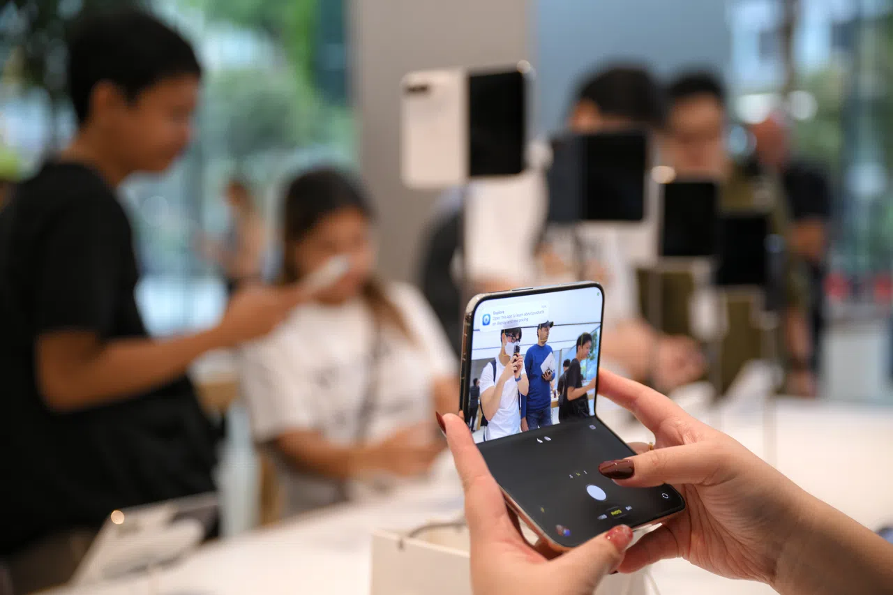 Customers look at the new Apple iPhone Duo at the Apple shop at Orchard Road after doors open at 8am on Oct 23, 2026.